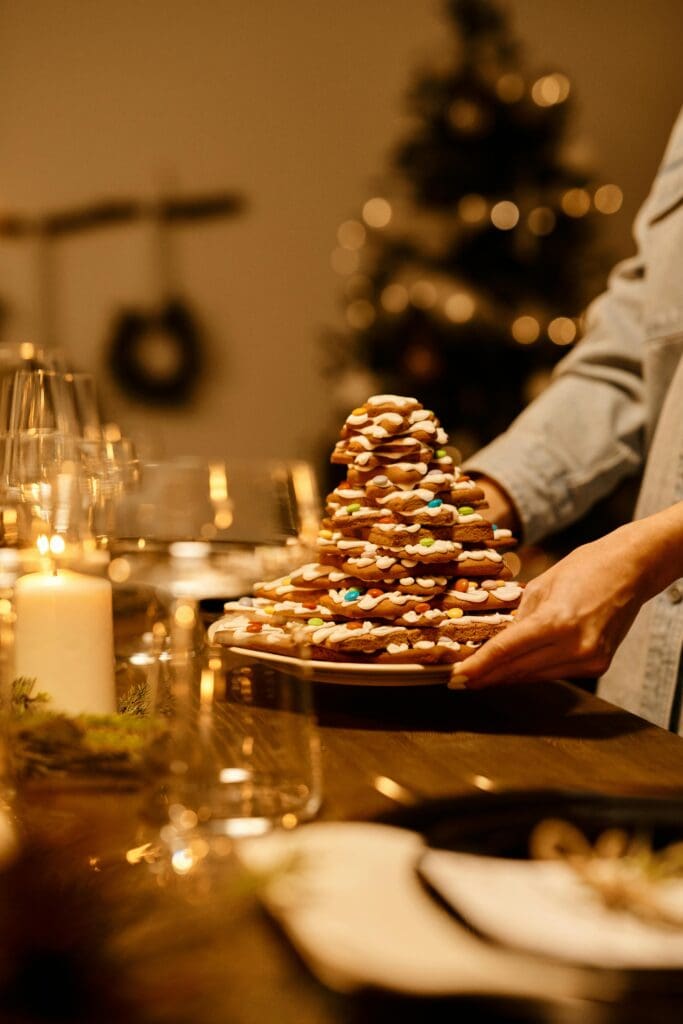 Christmas cookies stacked in a pyramid on a decorated table, capturing the holiday spirit.